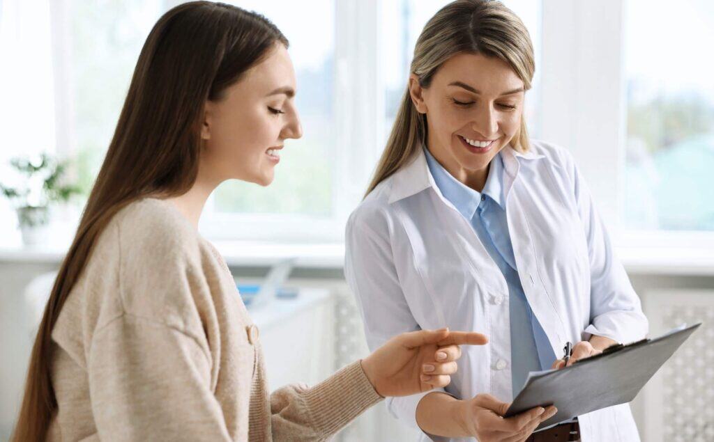 Woman consulting a clinician about the duration of TMS in Portland.