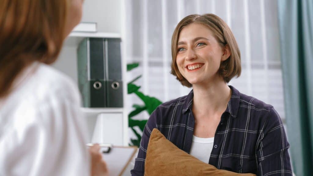 Woman feeling positive thanks to the science behind TMS therapy.