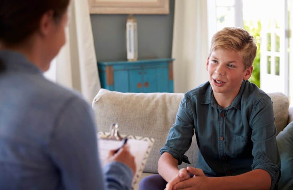 A young man enjoys aftercare therapy services after completing adolescent TMS in Portland.