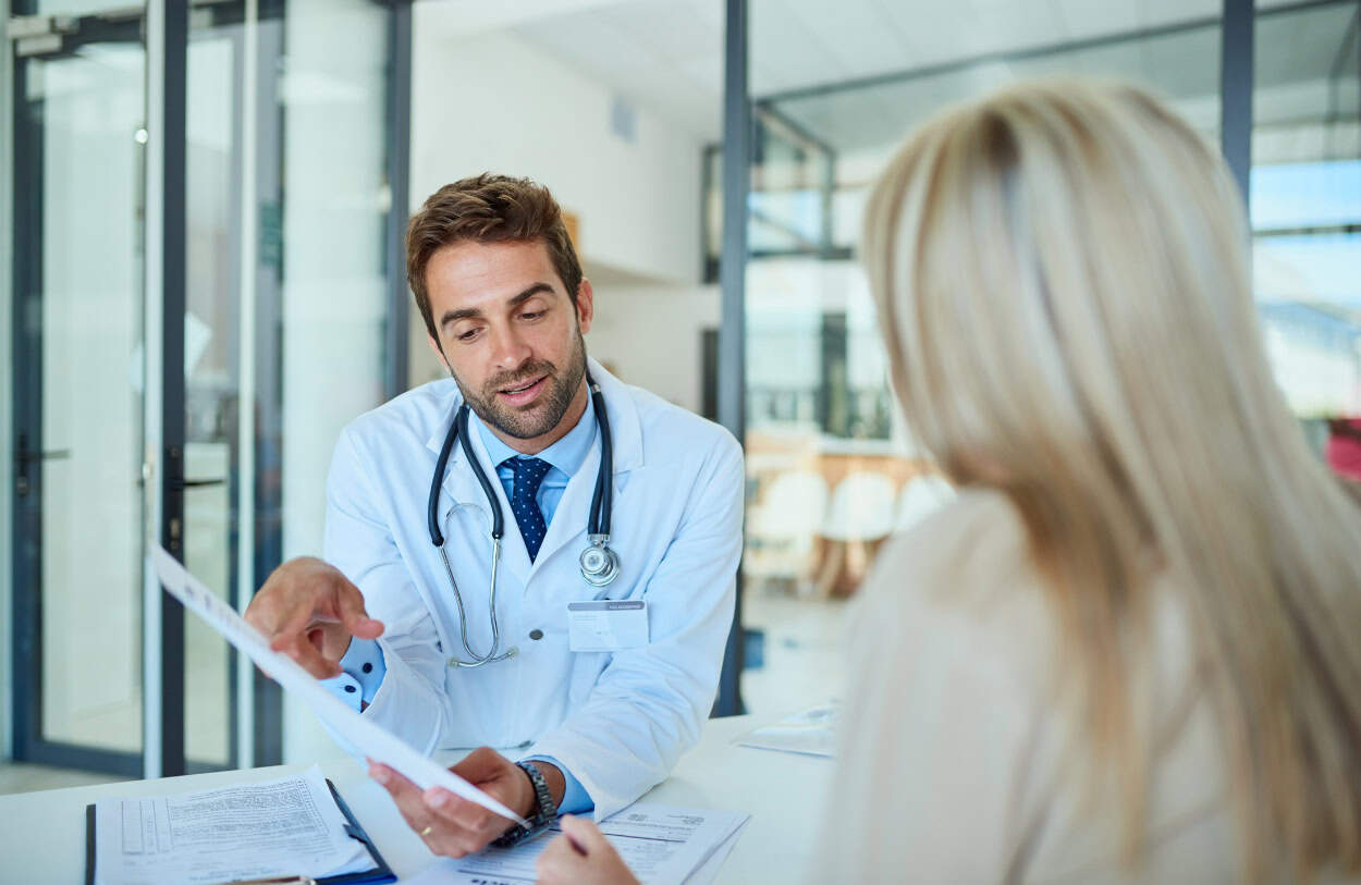 A physician helps a client find TMS providers near me for TMS recovery treatment.