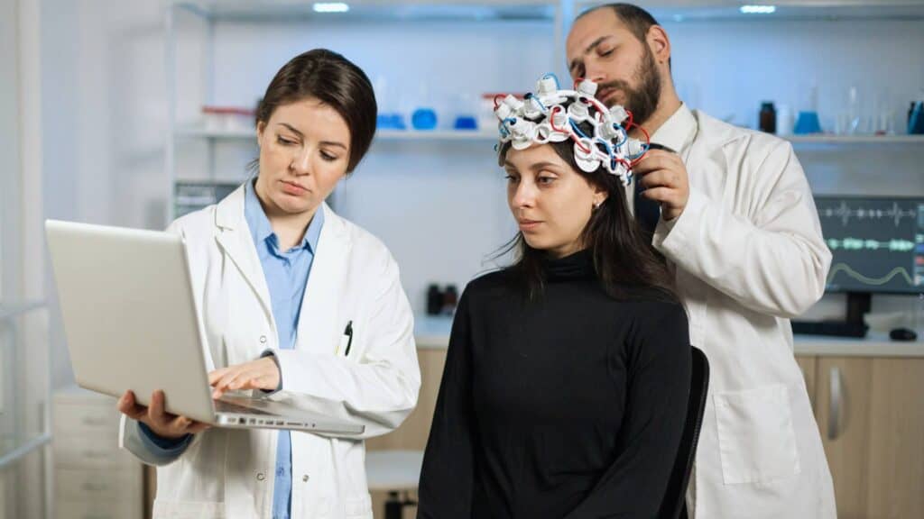 Healthcare staff guiding a woman through adult TMS in Portland.