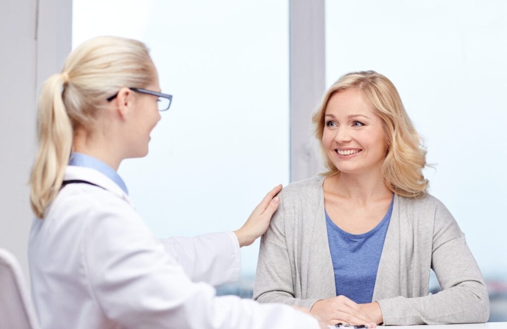 A woman talks to her doctor about the benefits of TMS treatment after learning more about TMS vs ECT.