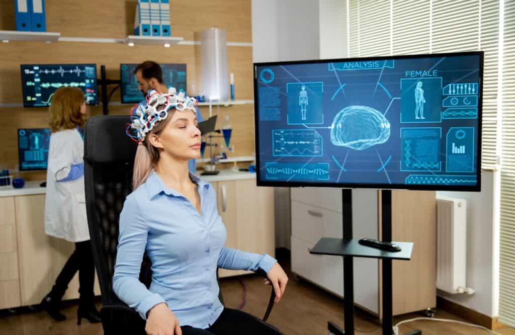 A woman enjoys TMS therapy after learning about tms and neuroplasticity.