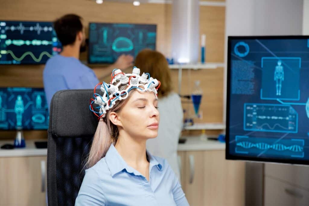 A woman relaxes during TMS treatment through Aetna TMS in Portland, OR.