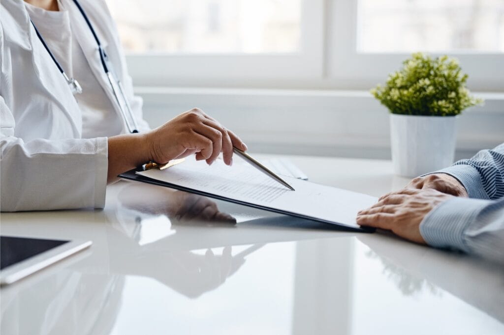 A man talks to his doctor about coverage through Aetna TMS in Portland.